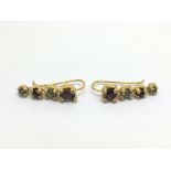 A pair of silver gilt gem set earrings.