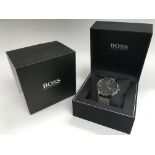 A boxed Hugo Boss gents watch.