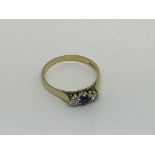 An 18ct gold ring set with a sapphire and 2 diamon