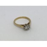 An 18ct gold ring set with diamond solitaire appro
