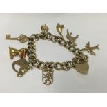 A heavy 9ct gold charm bracelet (2 charms 14ct). A