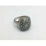 A platinum diamond and topaz cluster ring, approx
