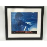 A framed and glazed signed movie card of Tom Cruise, approx 35.5cm x 32cm.