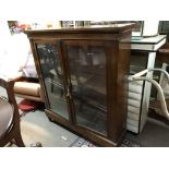 A glazed fronted 2 door bookcase.