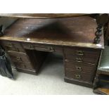 An oak desk inset with a leather top, approx 122cm