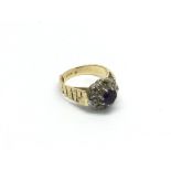 An 18ct gold ring set with a central amethyst, app