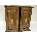 An inlaid Edwardian oak smokers cabinet. With shap