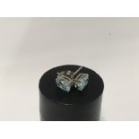 A pair of silver and blue topaz Stud earrings.
