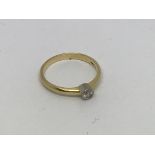 An 18ct gold ring set with diamond solitaire appro