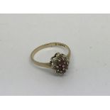 A 9ct gold ring set with small diamonds and 4 Ruby