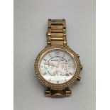 A Michael Kors rose gold tone ladies watch with su