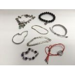 A small collection of silver bracelets, some set w