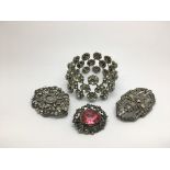 Three antique silver paste brooches and a bracelet