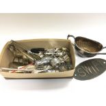 A box of cutlery and brass items.
