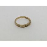An 18ct gold half eternity ring set with 9 diamond