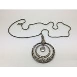 A sterling silver pendant on chain.