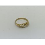 A small 18ct gold ring set with 5 diamonds. Size c