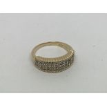 A 9ct gold half eternity ring set with 3 rows of d