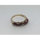 A 9ct gold ring set with 4 Ruby’s and diamonds. Si