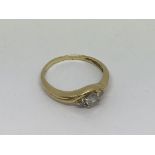 An 18ct gold ring set with diamond solitaire appro