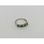 A 9ct gold ring set with 4 emeralds and small diam