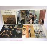 A collection of LPs by The Kingston Trio together