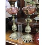 A pair of tall brass column oil lamps