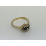 An 18ct gold ring set with 4 sapphires and 12 diam