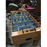 A modern table football game with blue and yellow players.