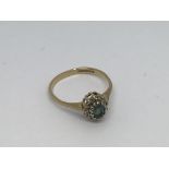 A 9ct gold ring set with a sapphire and diamond cl