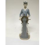 A large Lladro figure of a sailor figure at a ship