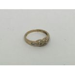 A 9ct gold kiss ring set with diamonds. Size m app