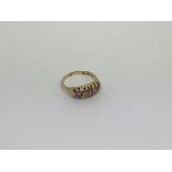 An 18ct gold ring set with 3 pink sapphires and di