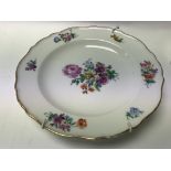 A Meissen porcelain plate decorated with flowers a