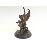 A spelter car mascot figure of a cherub playing a