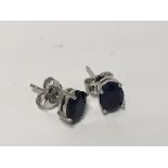 A pair of silver and sapphire set stud earrings.