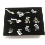 A collection of 12 new silver rings.