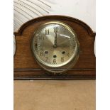 An oak case mantel clock the silvered dial with Ar