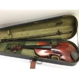 A cased violin and bow for restoration.