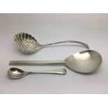 Three silver spoons including a William Comyns exa