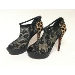A pair of ladies designer Christian Louboutin high heel shoes with simulated leopard skin and