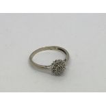 A 9ct white gold ring set with a rose shaped diamo