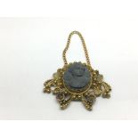 A Victorian high carat gold lava pendant, approx 7