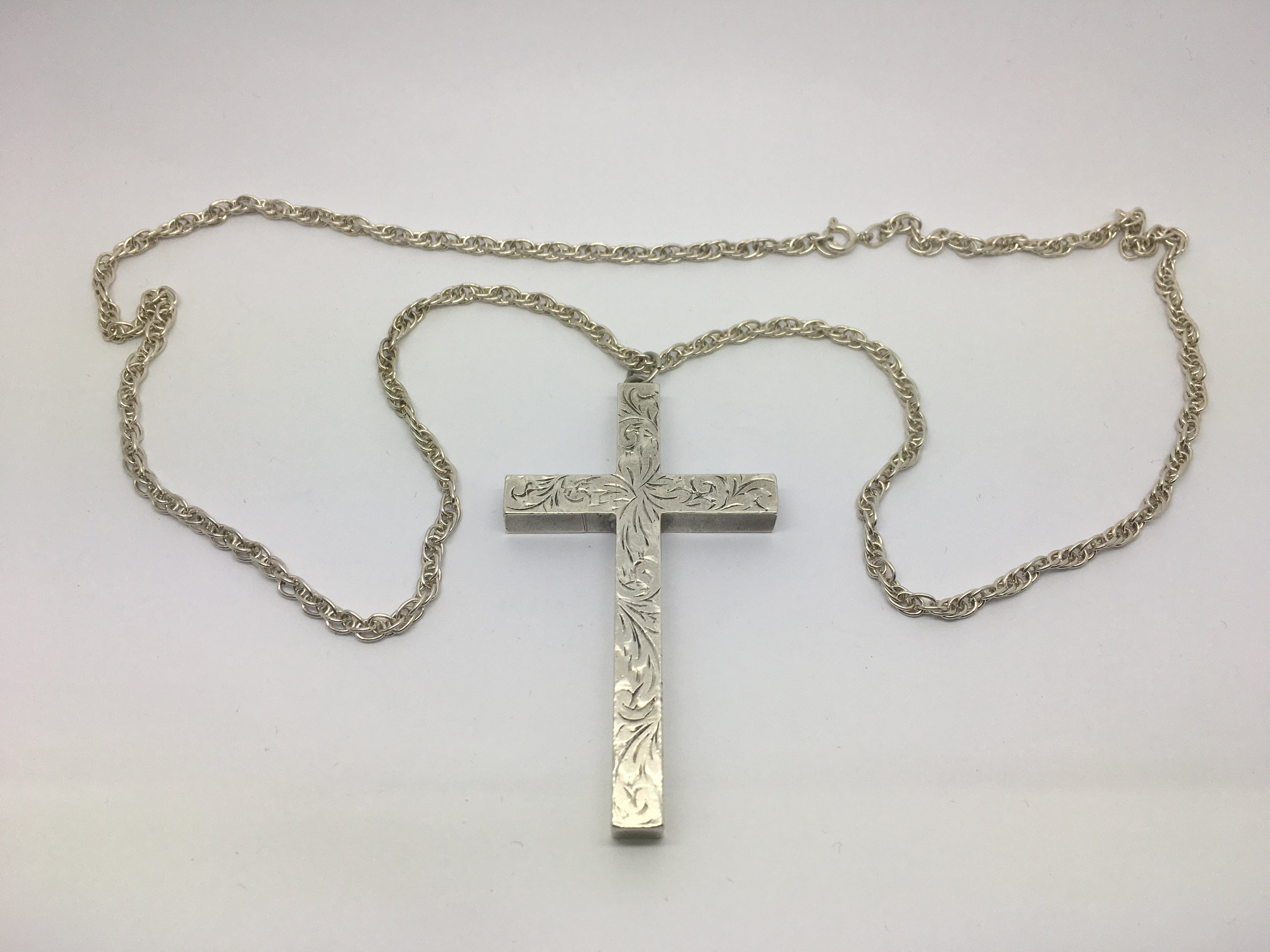 A heavy hallmarked silver cross on chain.