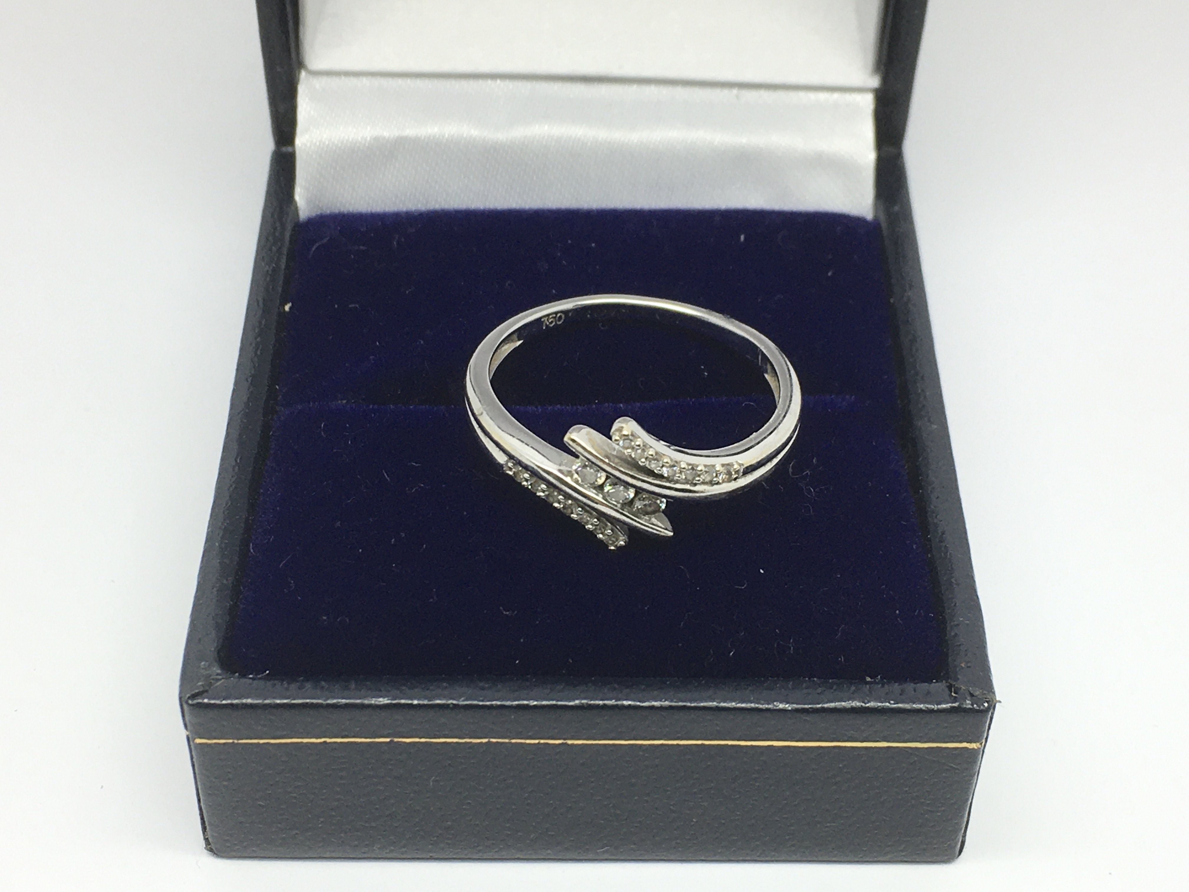 An 18ct white gold ring set with small diamonds, a