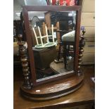 A Victorian dressing table mirror with turned supp