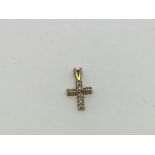 A 9ct gold cross pendant set with diamonds.