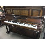A walnut cased upright piano maker Bluthner Leipzi