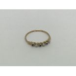 A fine 9ct gold ring set with sapphires and diamon