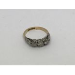 An 18ct gold And platinum ring set with 3 diamonds